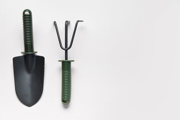 Gardening rake and shovel on white background