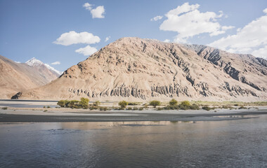 A panorama of the mountain landscape of the Wakhan Corridor and the Panj River in the valley with...