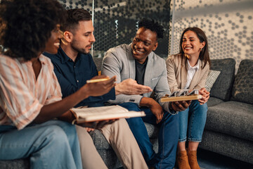 Diverse ecology experts with solar panel model working on sustainability