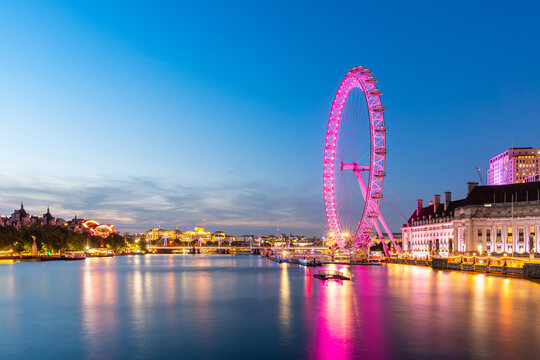 colorful London eye ferris wheel over river thames iconic famous travel destination landmark in center city of London near Big Ben and Westminster London at twilight time after sunset time in summer