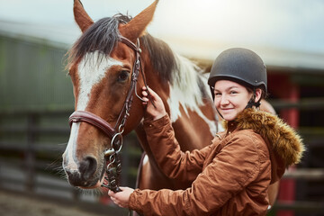 Horse, portrait and girl prepare bridle at farm for race, sport and training at countryside ranch. Animal, equestrian and adjust reins for riding with pet for safety, care and happy teenager outdoor
