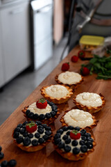 Delicious and Tasty Blueberry and Cream Tartlets Displayed on a Rustic Wooden Table