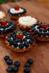Delicious and Tasty Blueberry and Cream Tartlets Displayed on a Rustic Wooden Table