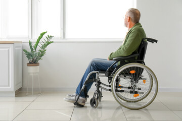 Senior man in wheelchair at home