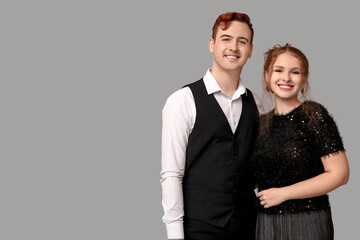 Young couple on grey background. Black Friday sale