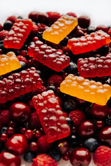 Colorful natural berry marmalade on fresh mixed fruits and berries, healthy sweet indulgence