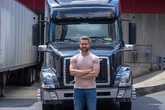 Truck driver. CDL. Portrait of trucker standing by his truck vehicle ready for transport. Male driver standing in front on his truck. Men driver near lorry trucks. Man owner truck driver. Millennial