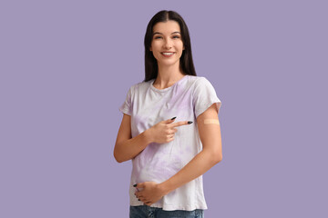 Young pregnant woman after vaccination on lilac background