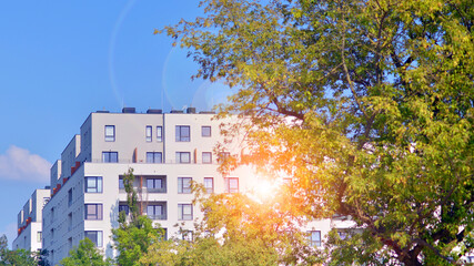 European residential architecture harmonizing with nature. Eco-friendly living in city with greens. Eco apartment building saving energy and fresh air concept. 