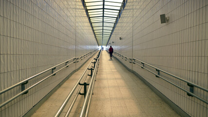Women go through the underpass at the train station