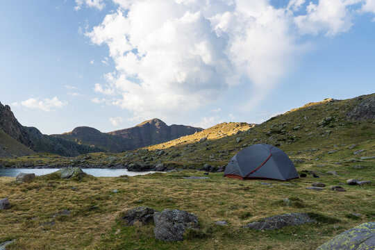 Solitary camping tent beside scenic lake in the French Pyrenees