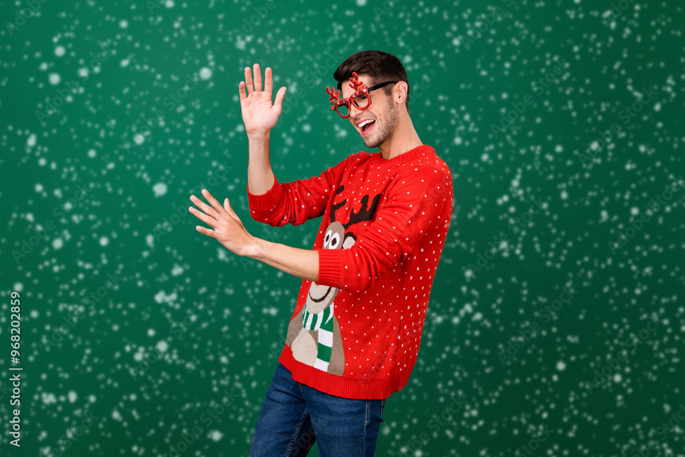 Poster profile side photo of young man happy positive smile have fun dance x-mas party glasses horns isolat