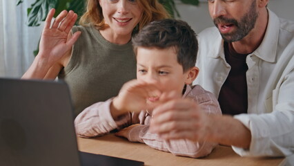 Excited family waving online videocall sitting at house closeup. People chatting