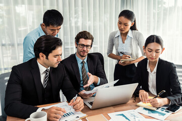 Diverse of business people from various ethnic group working in modern office environment. Productive and multi ethnic office workers engage in discussion for strategic business marketing. Meticulous