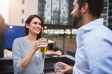 People, employees and smile in balcony with beer at pub for conversation and connection in New York. Business, partners and outside with glass of alcohol at bar for happy hour to relax and break
