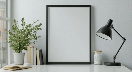 Modern workspace with blank frame and potted plants in bright natural light
