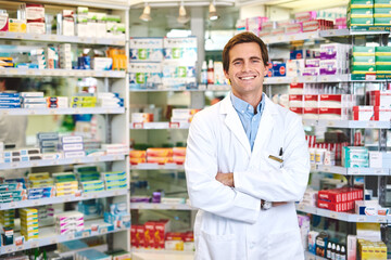 Pharmacy, pills and arms crossed with portrait of man in store for medicine, advice and healthcare. Medical, insurance and antibiotic prescription with pharmacist for help, drugstore and dispensary