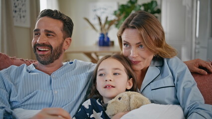 Obraz premium Funny family watching movie having fun at interior closeup. Girl eating popcorn