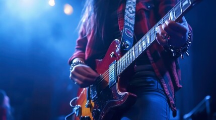 Obraz premium Close-up of a Guitarist's Hands Playing an Electric Guitar on Stage