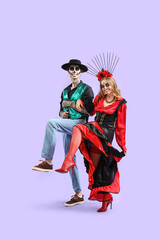 Young happy couple dressed for Mexico's Day of the Dead (El Dia de Muertos) dancing on purple background