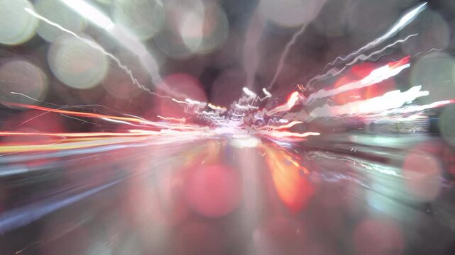 Timelapse of car driving on busy city streets at night. Drivelapse. road with lights reflected