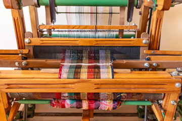  Wooden hand weaving machine. Weaving, traditional crafts, of a loom weaving, Woven silk,using cotton and silk string stretch and woven by using mechanic wooden machine to weave. Babadag Denizli.