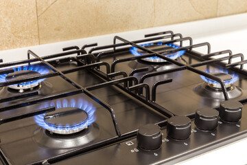 Gas burner on black modern kitchen stove