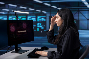 Engineer in server hub frightened by hacking attack on computers targeting sensitive user data....