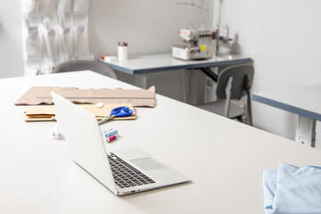 Empty cozy atelier of fashion designer dressmaker tailor workplace