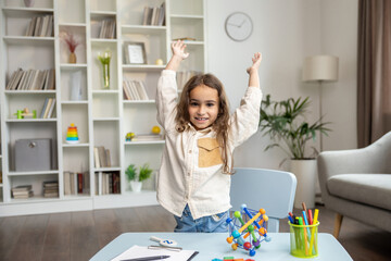 Cute long-haired girl of school girl in the office of a speech therapist