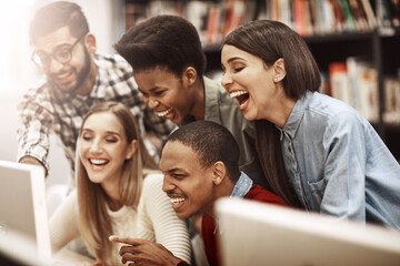 Obraz premium Computer, excited and students at library for research, knowledge and test results in college. University learning, friends and internet for education, project success and online exam report