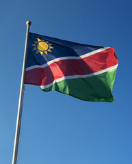 Namibia national flag swinging under the blue sky