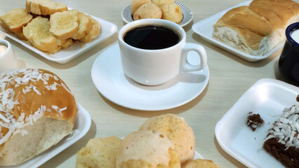Cup of coffee in the center of breakfast table.
