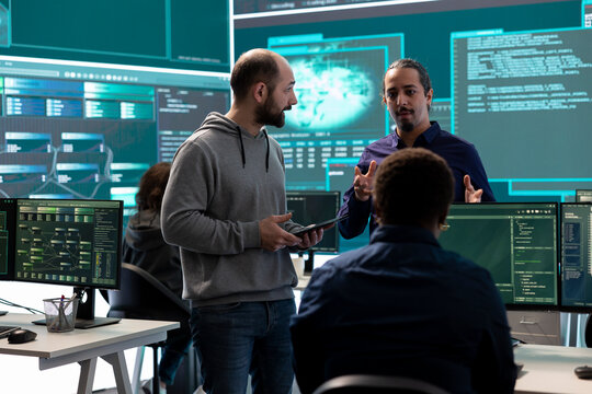 Cyber security team conducting cyber surveillance in a governmental control room. Experts group hacking activities, malware protection and data breach prevention in high tech agency.