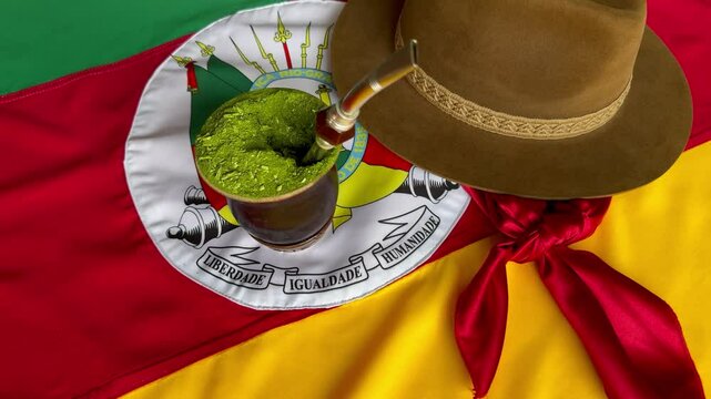 Chimarr&atilde;o, gaucho hat and scarf, and the Flag of the State of Rio Grande do Sul - Brazil, on the table. Traditional week in the South of Brazil, Farroupilha dos Ga&uacute;chos Week.