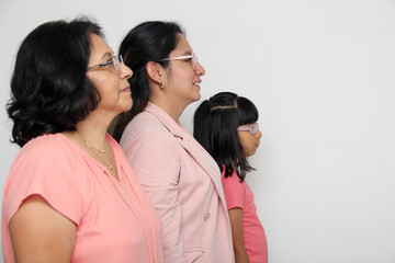 Family of grandmother, mother and daughter see with surprise and enthusiasm promotions and discounts that they are excited to buy