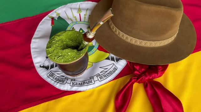 Chimarr&atilde;o, gaucho hat and scarf, and the Flag of the State of Rio Grande do Sul - Brazil, on the table. Traditional week in the South of Brazil, Farroupilha dos Ga&uacute;chos Week.