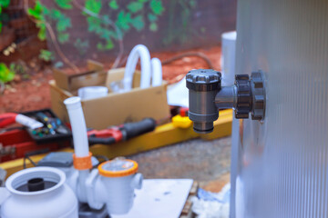 Installing water filtration system, chlorinating frame pool by maintenance service technician