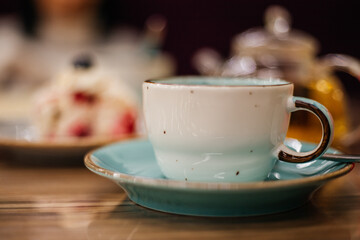 Beautiful ceramic mug in white and green color close-up