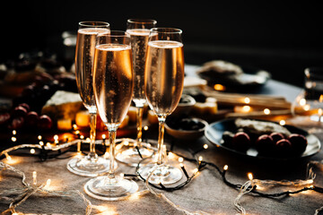 Glasses of sparkling wine or champagne served on the table for Christmas or New Year eve celebration.
