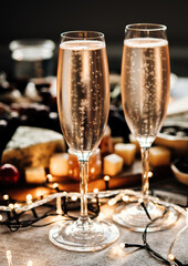 Glasses of sparkling wine or champagne served on the table for Christmas or New Year eve celebration.
