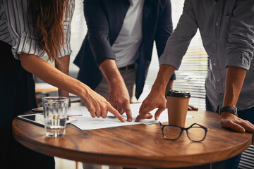 Strategy, pointing or hands of business people in meeting for document, teamwork or financial investment. Closeup, paperwork or budget analyst with economist with research, graphs or project plan