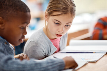 School, notebook and kids in classroom together with project for growth, development and teamwork for education. Diversity, learning and students with study for knowledge, exam and writing at desk