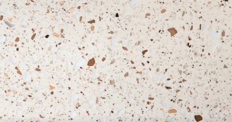 A textured surface featuring a mix of light colors and various small fragments, ideal for countertops or flooring.