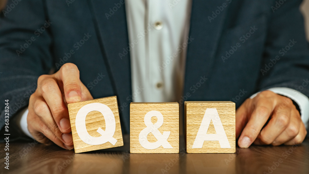 Poster there is notebook with the word q and a. it is an abbreviation for question and answer as eye-catchi