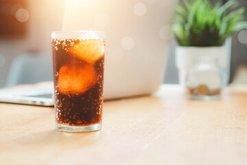 Glass of cola, Double cool ice soft drink cola carbonated liquid fresh food with soda water, Cola drinking with ice in glass ready to refresh you, A cola soft drink is placed on the desk.