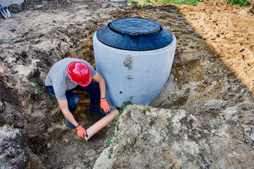 Connecting septic tank to external disposal system, installing out-flowing pipe through which wastewater will flow into leach field.
