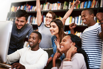 Students, computer and celebration in library for learning, study and education with exam collaboration. People, tech and diversity on university campus for research project, achievement and success