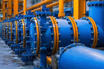 Industrial Machinery with Blue and Yellow Pipes in a Factory