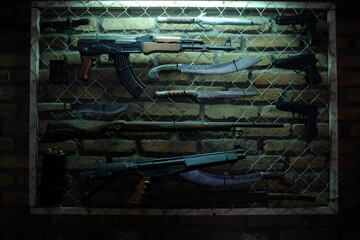 Various long-barreled firearms and sharp weapons stored in a secret room.